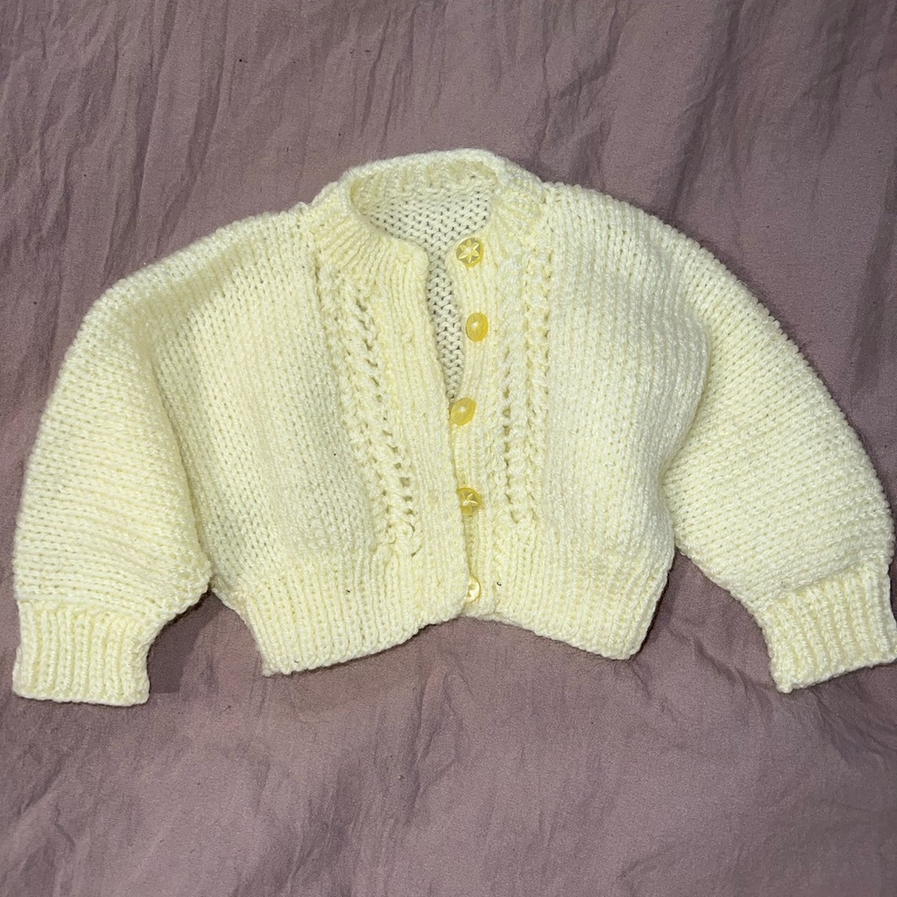 Yellow hand knitted sweater. Baby girl